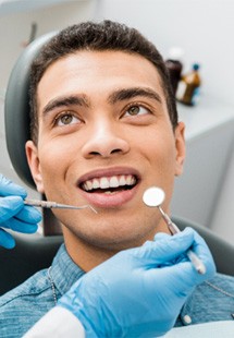 patient smiling while looking at dentist 