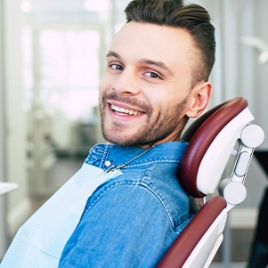 Patient smiling while sitting in treatment chair
