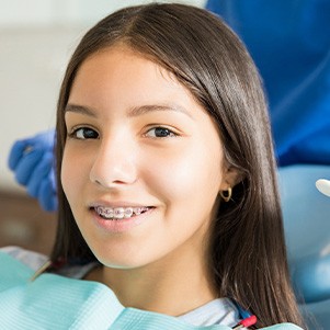 A close-up of a smiling woman with braces