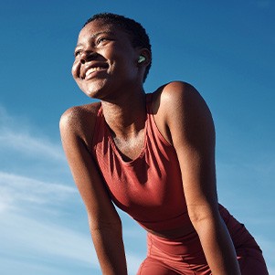 Woman smiling while exercising outside