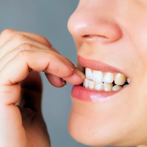 Closeup of patient biting their nails