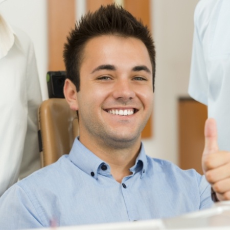 Smiling man giving a thumbs up
