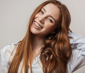Teen with braces smiles