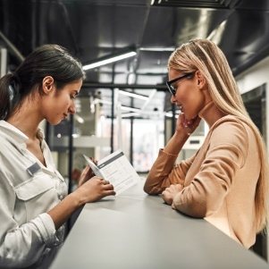 Two women talking at a desk