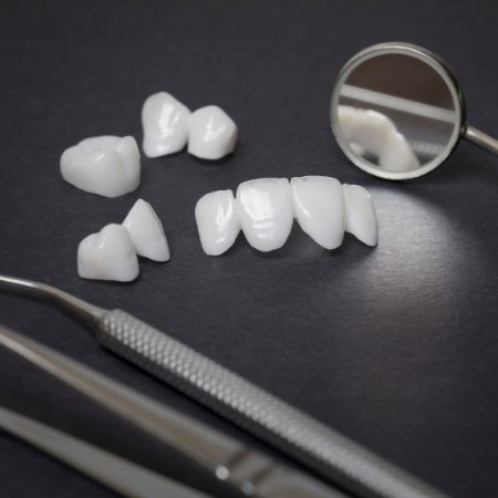 Bridges and crowns next to dental instruments