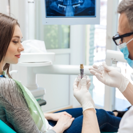 Man sitting in dental chair and smiling