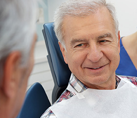 Smiling senior man in dental chair