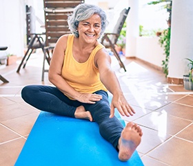 a person doing yoga outside on their back patio