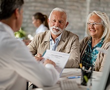 elderly couple at a dental implant consultation