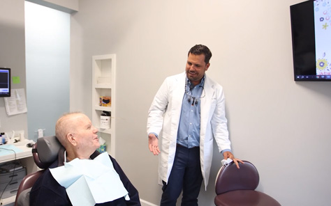 Woman talking to dentist in dental chair