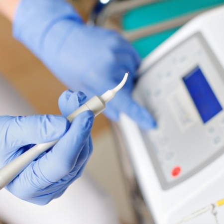 Gloved hands holding soft tissue laser in Port Orange