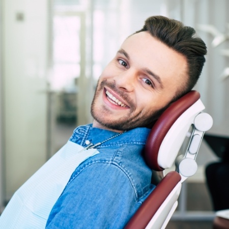Man sitting in dental chair smiling