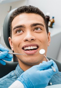 patient smiling while looking at dentist 