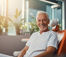 Man seated outside showing off results after a smile makeover