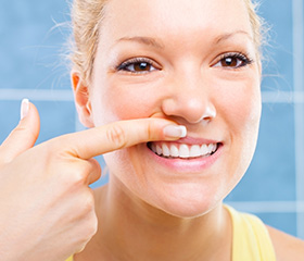 Woman looking at smile in mirror