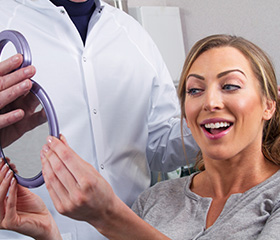 Woman looking at smile in mirror