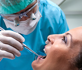 Woman receiving oral cancer screening