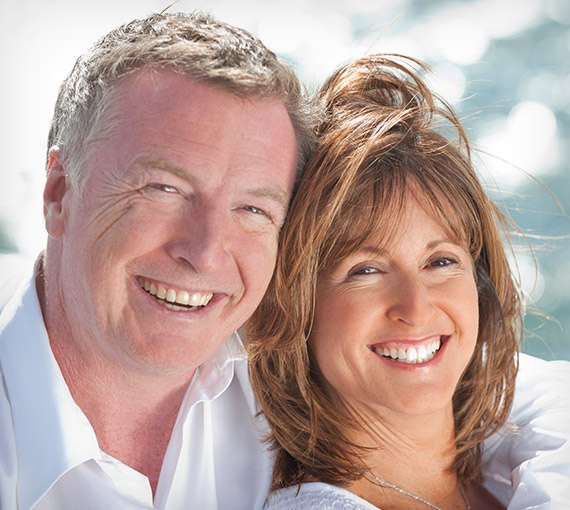 Older man and woman smiling outdoors