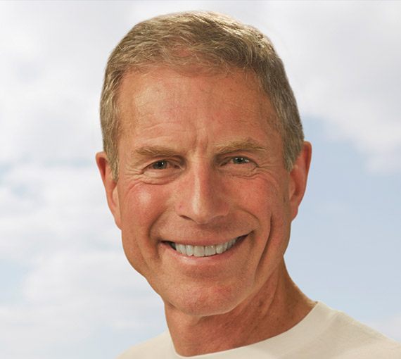Senior man in white shirt grinning