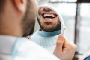 Man looking at his misaligned teeth