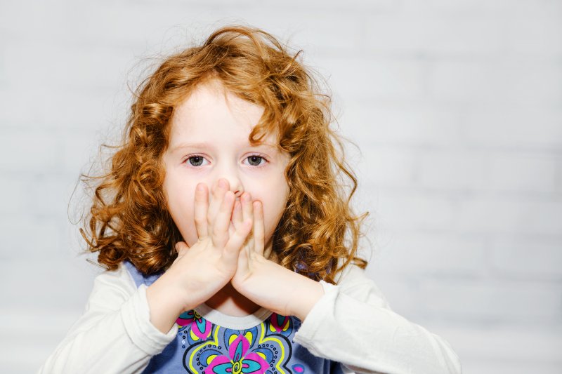 Child covering mouth