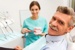 gray-haired man visiting his dentist for seniors in Port Orange 