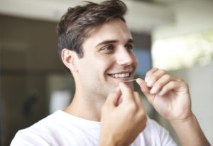 Man flossing teeth