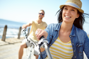 a couple smiling while visiting the beach