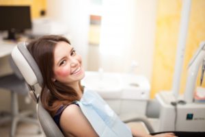 woman sitting in dentist chair smiling